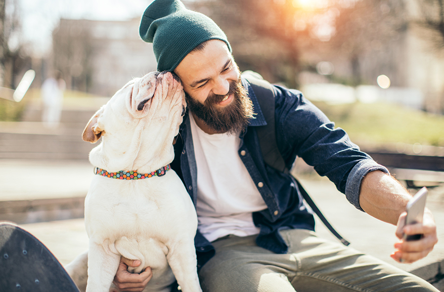 Young man taking a selfie with his dog